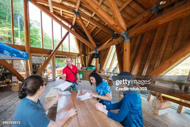 young woman signing waiver documents at an adventure park - tokushima prefecture stock pictures, royalty-free photos & images