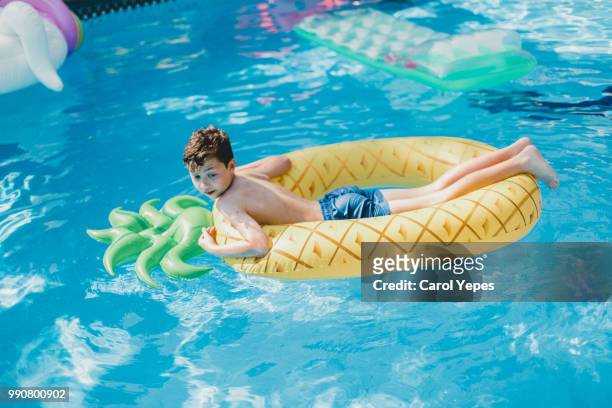 boy floating in   in pineaple  inflatable ring.pool - ot coruña fotografías e imágenes de stock