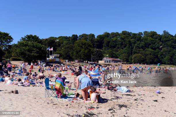 People enjoy the sun on Silver Sands beach at the start of the Scottish school holidays as the heatwave continues, on July 3, 2018 in Aberdour,...