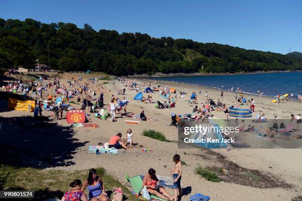 People enjoy the sun on Silver Sands beach at the start of the Scottish school holidays as the heatwave continues, on July 3, 2018 in Aberdour,...