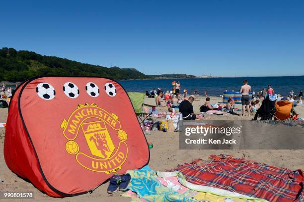 Manchester United beach tent on Silver Sands beach as people enjoy the sun at the start of the Scottish school holidays as the heatwave continues, on...