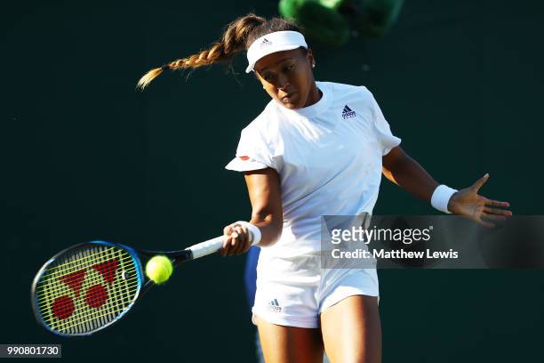 Naomi Osaka of Japan returns against Monica Niculescu of Romania during their Ladies' Singles first round match on day two of the Wimbledon Lawn...