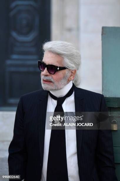 German fashion designer Karl Lagerfeld acknowledges the audience at the end of the Chanel 2018-2019 Fall/Winter Haute Couture collection fashion show...