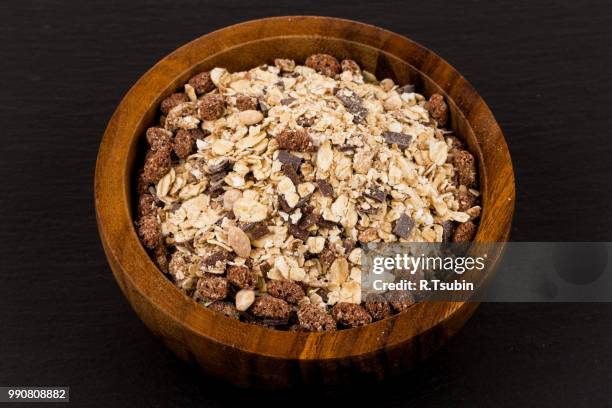 healthy oat granola muesli cereals with chocolate in a bowl on black stone - chocolate flake bildbanksfoton och bilder