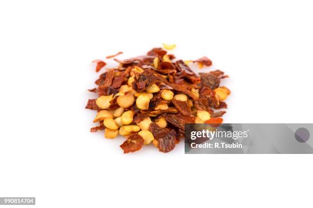 the pile of a crushed red pepper, dried chili flakes and seeds isolated on white background - seeded stock pictures, royalty-free photos & images