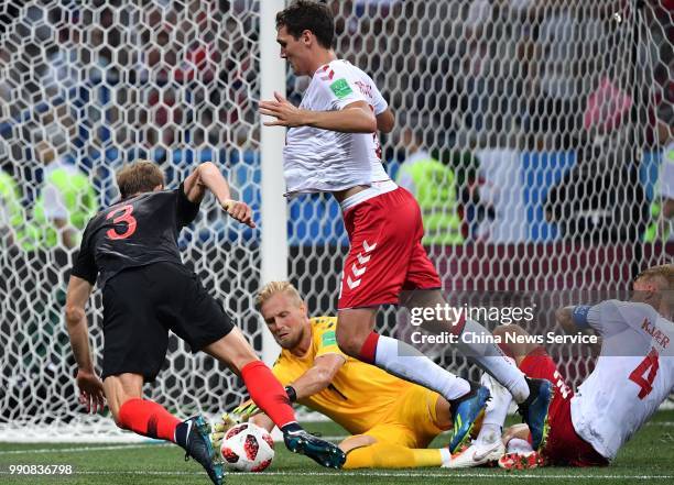 Ivan Strinic of Croatia shoots the ball against goalkeeper Kasper Schmeichel of Denmark during the 2018 FIFA World Cup Russia Round of 16 match...