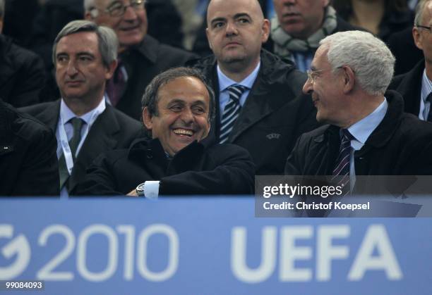 President Michel Platini smiles next to FA chairman Lord Triesman prior to the UEFA Europa League final match between Atletico Madrid and Fulham at...
