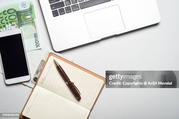 office table with european union currency european union currency banknotes, laptop, smartphone copy space - arijit mondal stock pictures, royalty-free photos & images