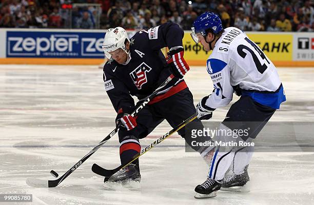 Sami Kapanen of Finland and Kyle Okposo of USA battle for the puck during the IIHF World Championship group A match between Finland and USA at...