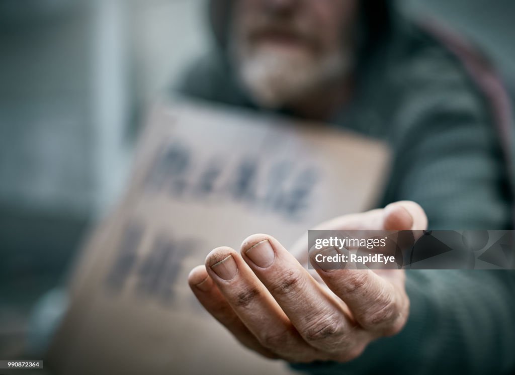 Outstretched hand of pathetic beggar