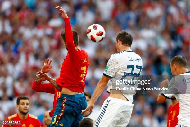 Gerard Pique of Spain competes with Artyom Dzyuba of Russia during the 2018 FIFA World Cup Russia Round of 16 match between Spain and Russia at...