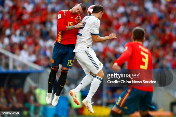 Sergio Ramos of Spain competes with Artyom Dzyuba of Russia during the 2018 FIFA World Cup Russia Round of 16 match between Spain and Russia at...