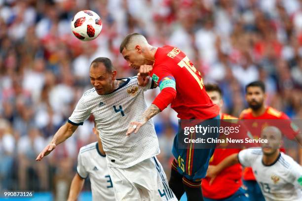 Sergio Ramos of Spain competes with Sergey Ignashevich of Russia during the 2018 FIFA World Cup Russia Round of 16 match between Spain and Russia at...