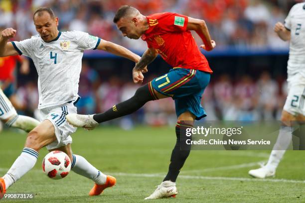 Iago Aspas of Spain competes with Sergey Ignashevich of Russia during the 2018 FIFA World Cup Russia Round of 16 match between Spain and Russia at...