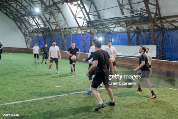 amateur soccer defense player intercepting the offense action - futsal stock pictures, royalty-free photos & images