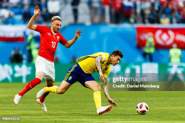 Josip Drmic of Switzerland and Victor Lindelof of Sweden focused on the ball during the 2018 FIFA World Cup Russia Round of 16 match between Sweden...