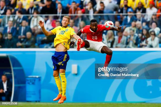 Ola Toivonen of Sweden in a header with Johan Djourou of Switzerland during the 2018 FIFA World Cup Russia Round of 16 match between Sweden and...