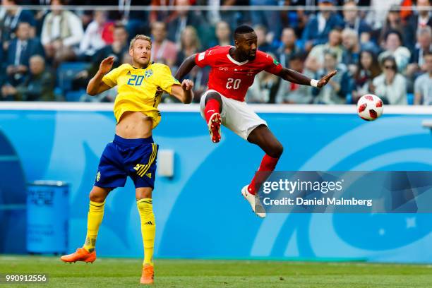 Ola Toivonen of Sweden in a header with Johan Djourou of Switzerland during the 2018 FIFA World Cup Russia Round of 16 match between Sweden and...