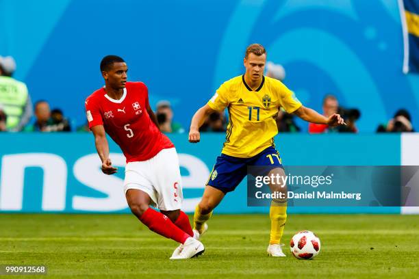 Manuel Akanji of Switzerland and Viktor Claesson of Sweden focused on the ball during the 2018 FIFA World Cup Russia Round of 16 match between Sweden...