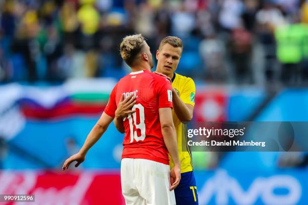 Viktor Claesson of Sweden gives Josip Drmic of Switzerland a hug after the 2018 FIFA World Cup Russia Round of 16 match between Sweden and...
