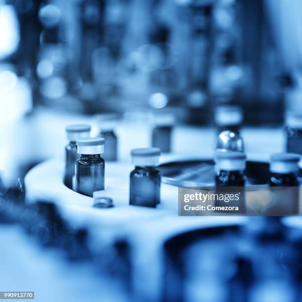 reagents bottle at annulus production line - comezora stock-fotos und bilder