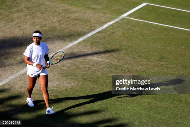 Naomi Osaka of Japan walks on the court during her Ladies' Singles first round match against Monica Niculescu of Romania on day two of the Wimbledon...