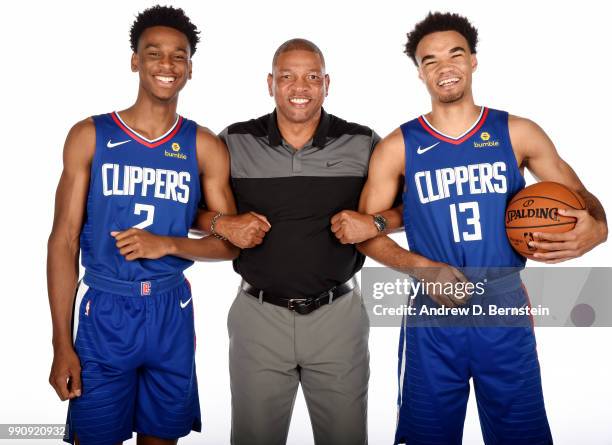 Draft picks Shai Gilgeous-Alexander and Jerome Robinson of the LA Clippers pose for a photo with Head Coach Doc Rivers during the Draft Press...