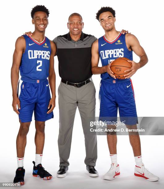 Draft picks Shai Gilgeous-Alexander and Jerome Robinson of the LA Clippers pose for a photo with Head Coach Doc Rivers during the Draft Press...