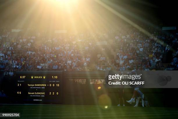 Player Tennys Sandgren serves against Serbia's Novak Djokovic during their men's singles first round match on the second day of the 2018 Wimbledon...