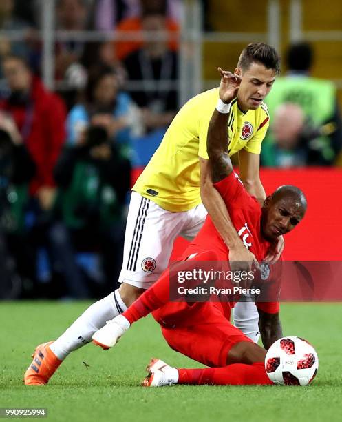 Santiago Arias of Colombia tackles Ashley Young of England during the 2018 FIFA World Cup Russia Round of 16 match between Colombia and England at...