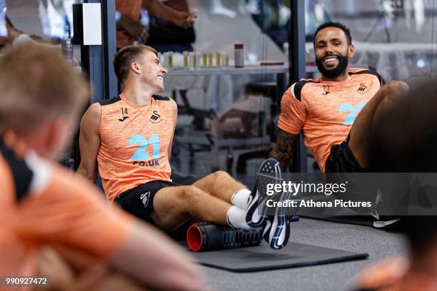 Tom Carroll and Kyle Bartley exercise in the gym during a Swansea City Training Session at The Fairwood Training Ground on July 03, 2018 in Swansea,...