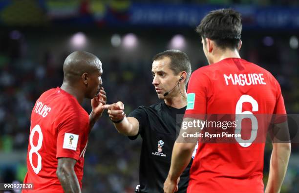 Referee Mark Geiger speaks with Ashley Young of England during the 2018 FIFA World Cup Russia Round of 16 match between Colombia and England at...