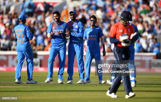 Umesh Yadav of India celebrates with teammates after dismissing Chris Jordan of England during the 1st Vitality International T20 match between...