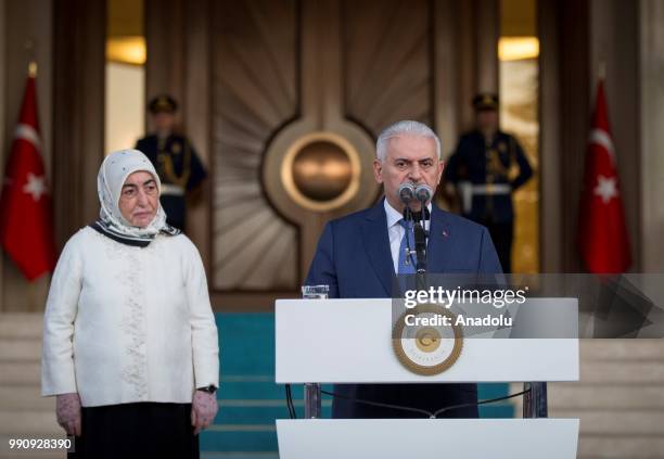 Turkish Prime Minister Binali Yildirim makes a speech as he is flanked by his wife Semiha Yildirim during a farewell programme at the official...