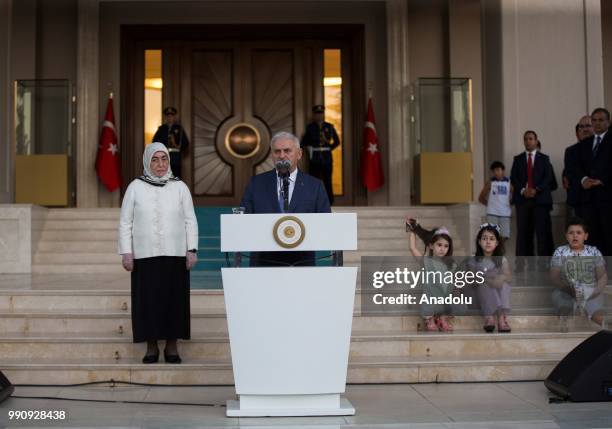 Turkish Prime Minister Binali Yildirim makes a speech as he is flanked by his wife Semiha Yildirim during a farewell programme at the official...