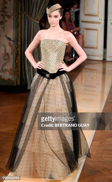Model presents a creation by Giorgio Armani during the 2018-2019 Fall/Winter Haute Couture collection fashion show in Paris, on July 3, 2018.