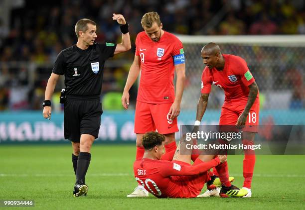 Dele Alli of England is helped by team mates Ashley Young and Harry Kane during the 2018 FIFA World Cup Russia Round of 16 match between Colombia and...