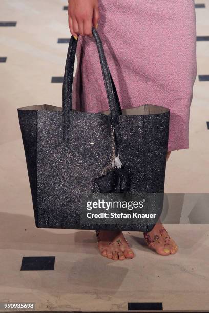 Model, bag detail, walks the runway at the Anja Gockel show during the Berlin Fashion Week Spring/Summer 2019 at Hotel Adlon on July 3, 2018 in...