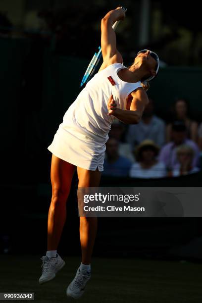 Kirsten Flipkens of Belgium serves against Heather Watson of Great Britain during their Ladies' Singles first round match on day two of the Wimbledon...