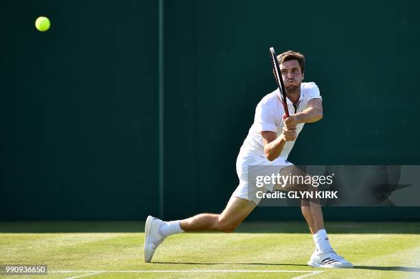 France's Gilles Simon returns against Georgia's Nikoloz Basilashvili during their men's singles first round match on the second day of the 2018...