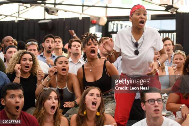 England fans react as they watch the FIFA 2018 World Cup Finals match between Colombia and England at Boxpark on July 3, 2018 in London, England....