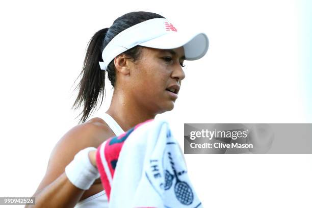 Heather Watson of Great Britain wipes her face with a towel during her Ladies' Singles first round match against Kirsten Flipkens of Belgium on day...