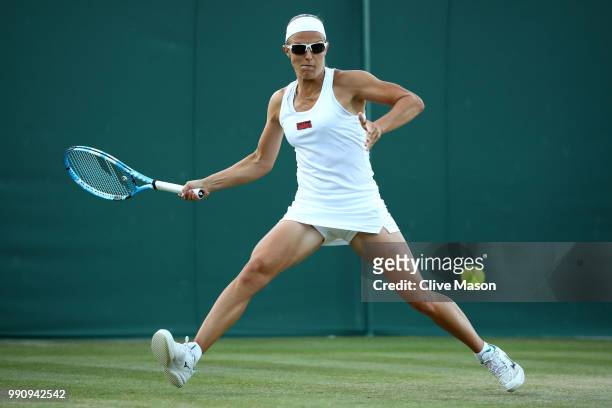 Kirsten Flipkens of Belgium returns against Heather Watson of Great Britain during their Ladies' Singles first round match on day two of the...