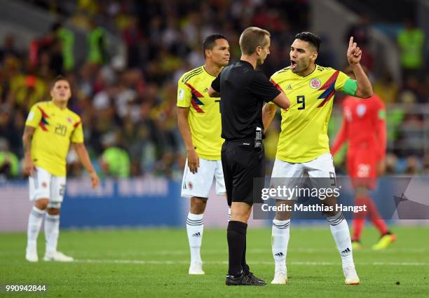 Radamel Falcao and Carlos Bacca of Colombia argue with Referee Mark Geiger during the 2018 FIFA World Cup Russia Round of 16 match between Colombia...