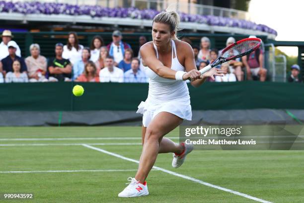 Jana Fett of Croatia returns against Daria Kasatkina of Russia during their Ladies' Singles first round match on day two of the Wimbledon Lawn Tennis...