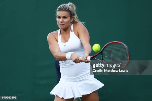 Jana Fett of Croatia returns against Daria Kasatkina of Russia during their Ladies' Singles first round match on day two of the Wimbledon Lawn Tennis...