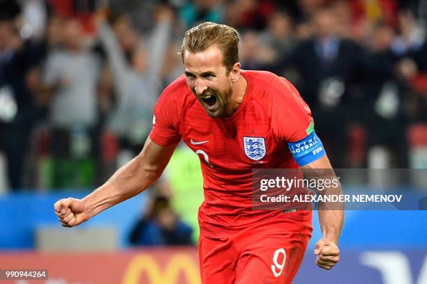 England's forward Harry Kane celebrates after scoring the opening goal from the penalty spot during the Russia 2018 World Cup round of 16 football...