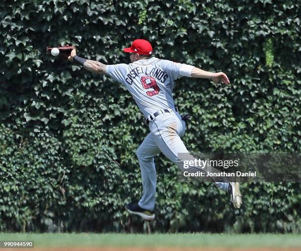 The ball goes off the glove of Nicholas Castellanos of the Detroit Tigers on a hit by Addison Russell of the Chicago Cubs in the 3rd inning at...