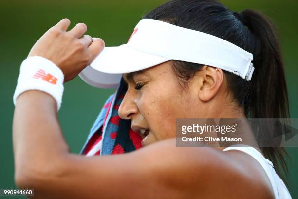 Heather Watson of Great Britain wipes her face with a towel during her Ladies' Singles first round match against Kirsten Flipkens of Belgium on day...