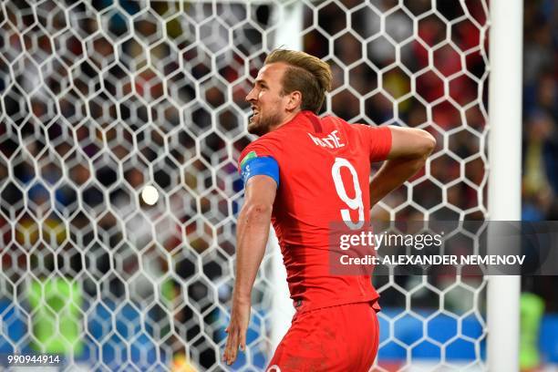 England's forward Harry Kane celebrates after scoring the opening goal from the penalty spot during the Russia 2018 World Cup round of 16 football...